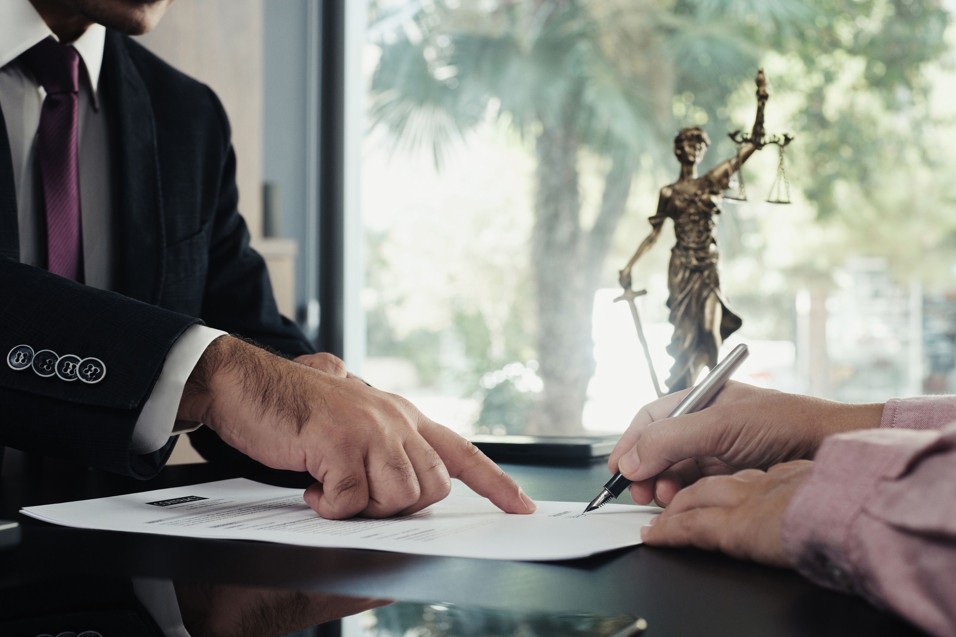 Lawyer and the client signing legal agreement documents